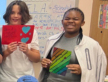 students holding cards